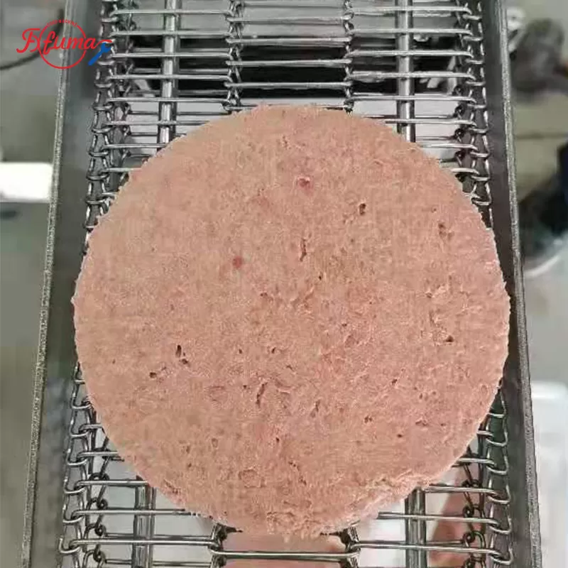 meat patty on the machine belt